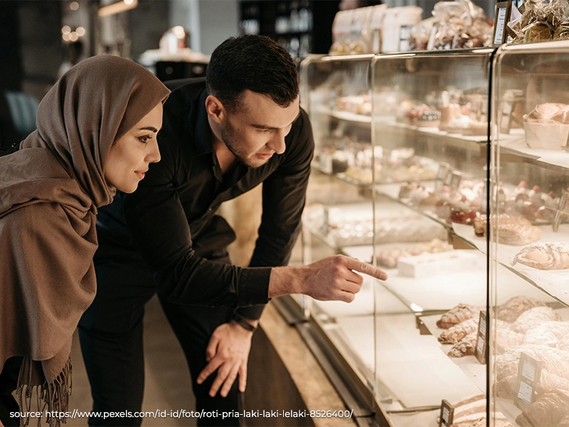 Customers viewing products in an attractive retail display case that enhances shopping experience